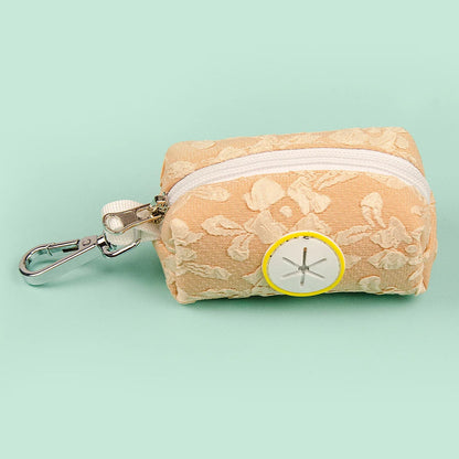 Distributeur de sac à crotte orange vitaminé avec motif fleuri