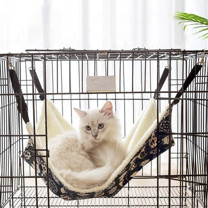 hamac à chat suspendu dans une cage